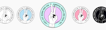 The different color versions of the sticker of the Girls Just Wanna Have Fun-damental Rights and Equal Pay movement