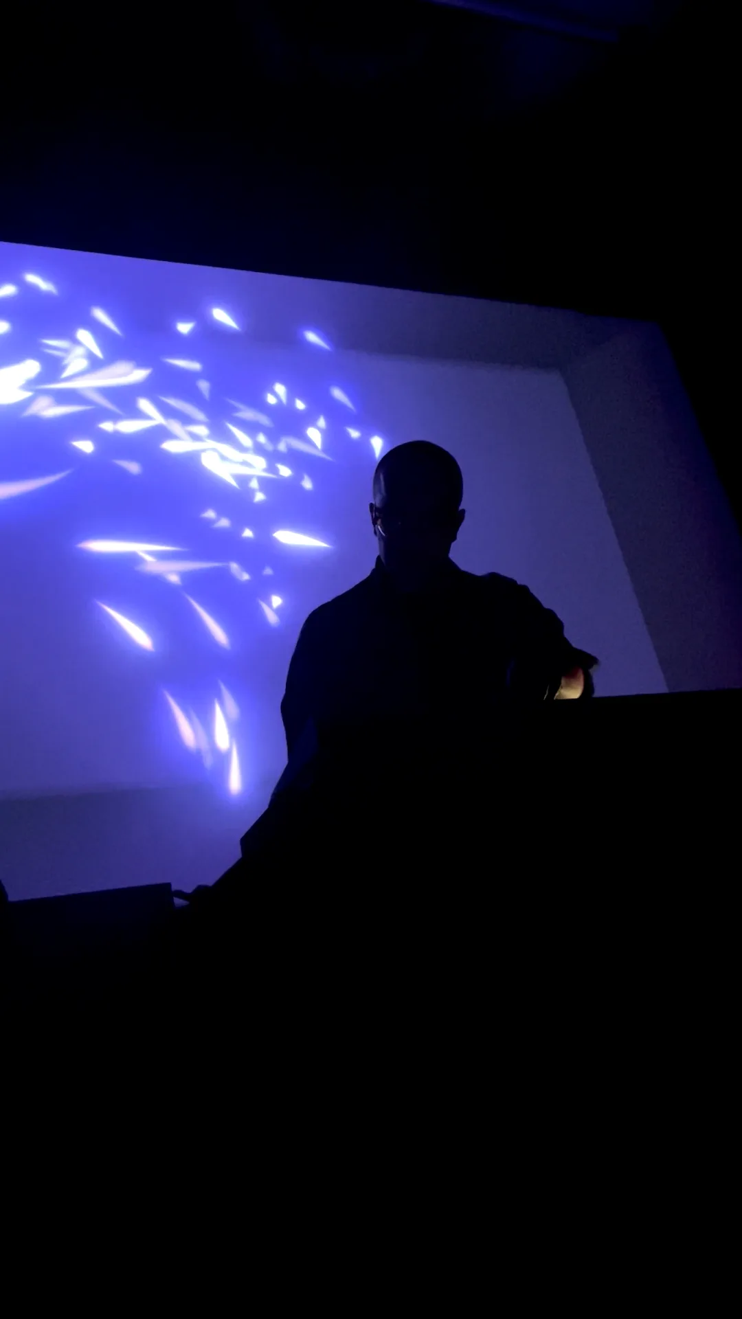 Virtual flocks of fish glowing in dark blue color.